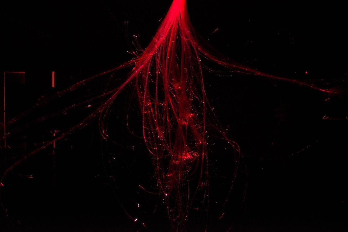 Close detail of the fibre-optic strands, shifted to red
