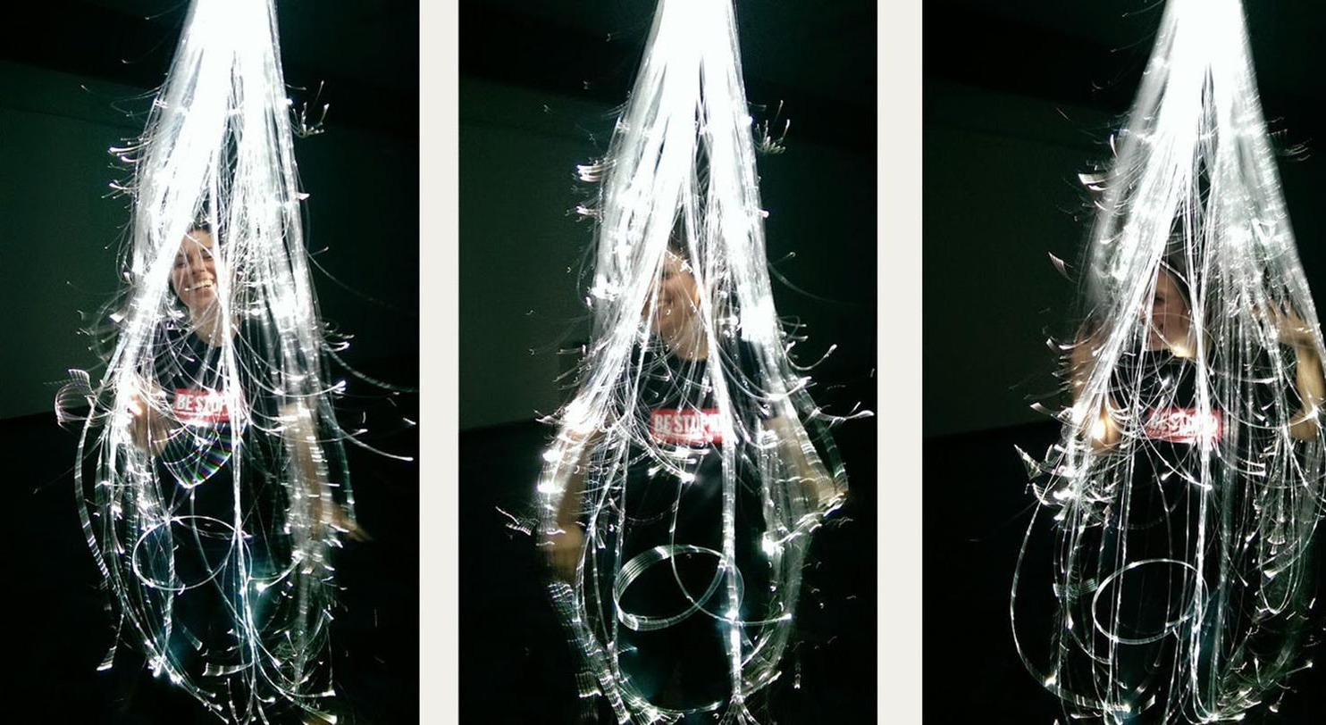 A visitor engaging with OpticTendril, three sequential moments