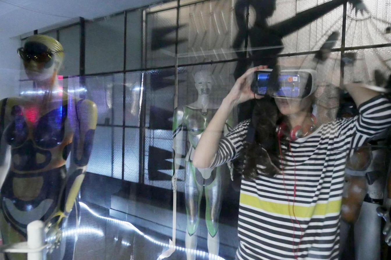 The visitor, headset on, mid-immersion
